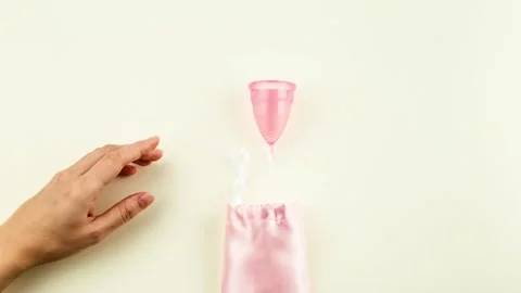 Menstrual Cup is moving out of the pink storage bag. Stock Footage 164918383