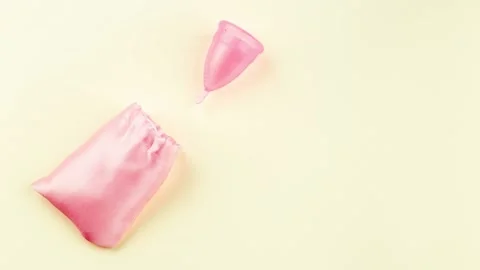 Menstrual Cup is moving into the pink storage bag. Stop motion Stock Footage 164918384