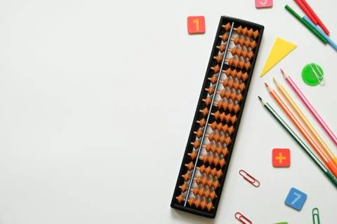 Mental arithmetic and math concept: colorful pens and pencils, numbers, abacus Stock Photos