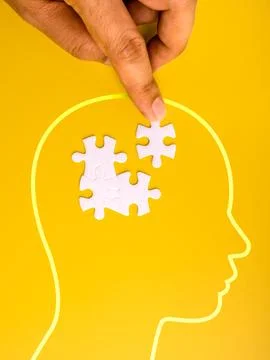 Mental health and problem solving concept with human hand placing puzzle pi.. 写真素材