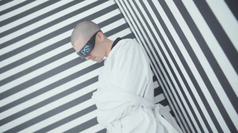 Mental patient with black goggles in a straitjacket Stock Footage 258177631