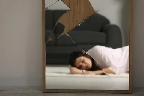 Mental problems. Blurred reflection of depressed woman in mirror indoors Stock Photos