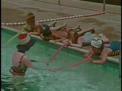 Mentally challenged children learn breath control using tubes in a swimming Video stock 74934764