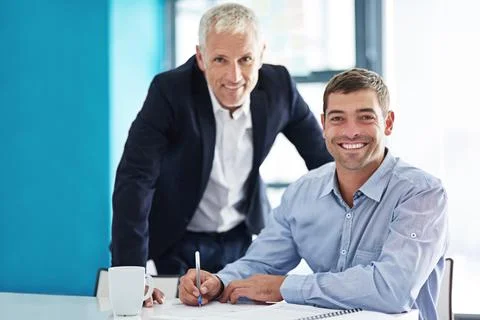Mentor and apprentice. Cropped portrait of two businessmen working together in Stock Photos