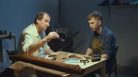 Mentor and apprentice. Shoemaker's tools Video stock 127837198