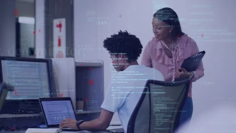 Mentor approaching right, leaning over dev typing on laptop while guiding, code Stock Footage 333004769
