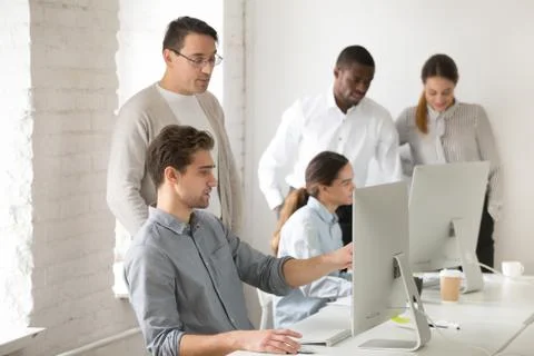 Mentor consulting intern about computer task, helping with onlin Stock Photos