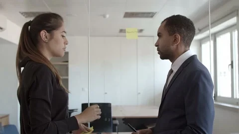 Mentor explaining young employee how to work with memos Stock Footage 137509747