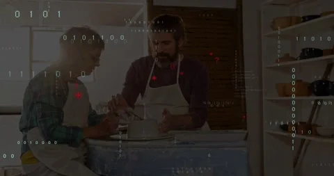 Mentor guiding learner on wheel, centering clay for art class while code overlay 스톡 동영상 331789971