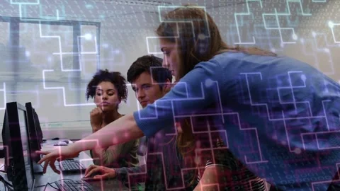 Mentor leaning over students at computers, pointing and guiding mouse, teaching Stock Footage 334337993