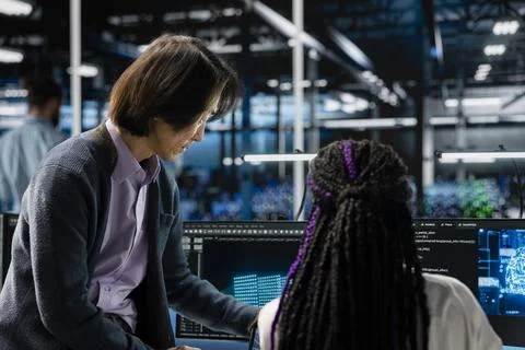 Mentor teaching intern in data center to install server racks systems with AI Stock Photos