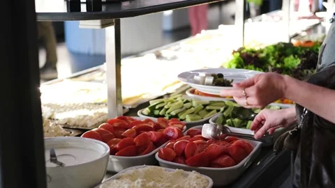 Menu in all-inclusive. Women's hands put food on a plate. Stock Footage 178333066