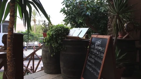 Menu board under trees of small town bar Stock Footage 84930214