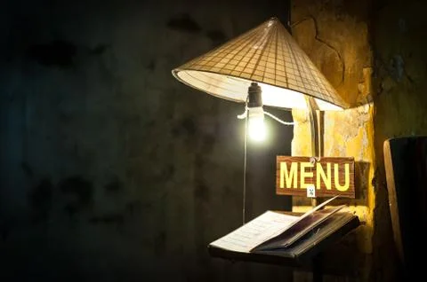 Menu in cafe under light of bulb in rice hat. Stock Photos