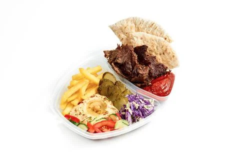 Menu combo - hummus with vegetable salad, French fries, pita and beef shawarm Stock Photos