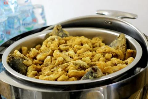 A menu of crispy fried intestines as a side dish to accompany the main meal. Stock Photos
