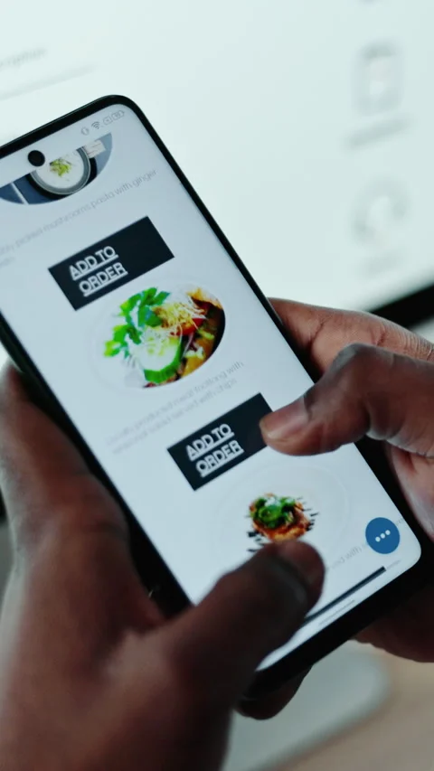 Menu, delivery app and hands in office with phone screen, scrolling and takeaway 動画素材 332890821