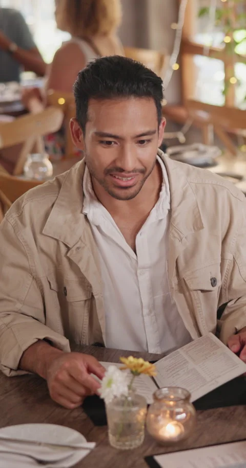 Menu, man and talking in restaurant on date for order choice, suggestion or Stock Footage 340627554