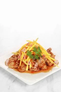 The menu of a restaurant called Mango Chicken. Flour fried chicken with spi.. Stock Photos
