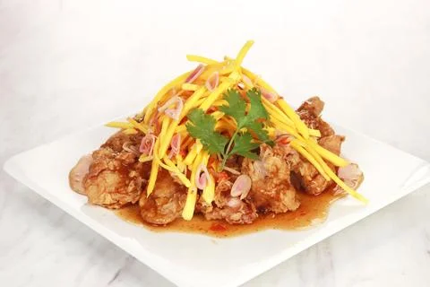The menu of a restaurant called Mango Chicken. Flour fried chicken with spi.. Stock Photos