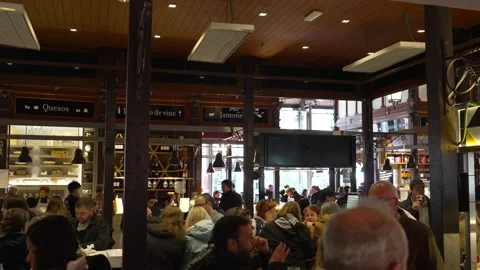 Mercado de San Miguel interior food hall with tapas counters and crowd Madrid Stock Footage 334962079