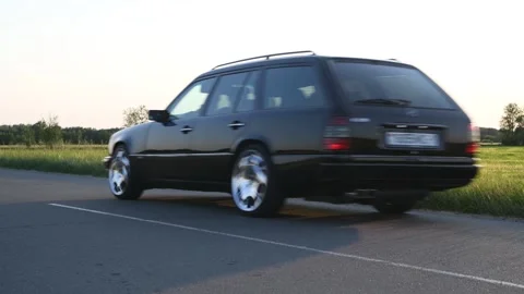 Mercedes-Benz E-Class E220 S124 moves along the road. Stock Footage 295770741