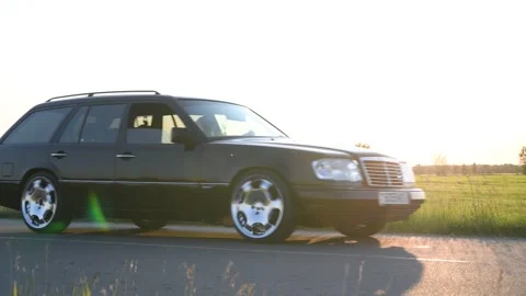 Mercedes-Benz E-Class E220 Wagon S124 moves along the road. Video stock 295770831
