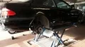 Mercedes CLK in service garage on lifting plattform for seasonal changing tyres 4k or 4k+ Resolution