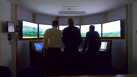 Merchant marine cadets in a ship simulator, viewing the graphics from the Stock Footage 107092568