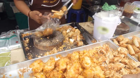 Merchant preparing fried snack for customer Stock Footage 60222014