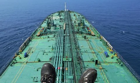 A merchant ship is underway at sea, view from the mast Stock Photos