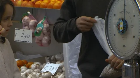 Merchant ties a knot on a small plastic groceries bag. Stock Footage 85234871