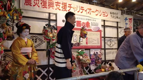 Merchants in happi jacket doing a hand clapping in Ootori shrine. Stock Footage 141289291