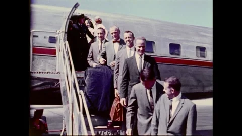 Mercury Program original seven astronauts pose for photo getting off airplane Stock Footage 263292163