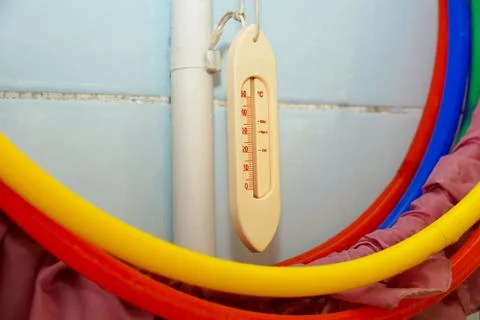 Mercury thermometer and bathing accessories in the children's pool in kinderg Stock Photos