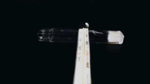 Mercury thermometer display on a black surface. The camera moves smoothly Stock Footage 127673147
