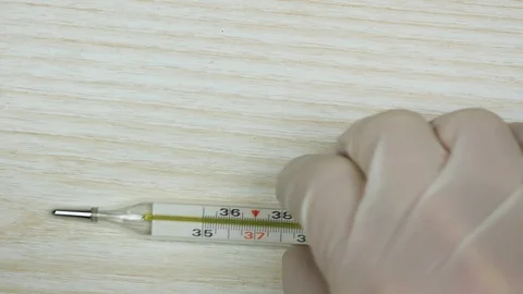 Mercury thermometer with a high temperature on the table. Place for text Stock-Footage 125982479