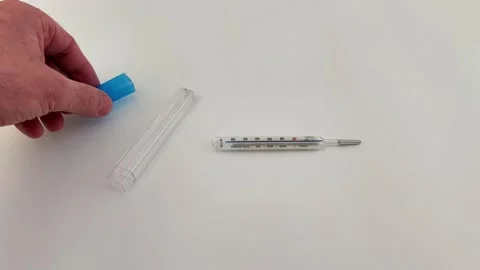 Mercury Thermometer with Plastic Case on White Surface 動画素材 330051210