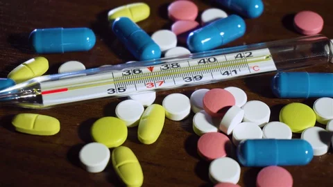 Mercury thermometer using animation shows temperature of 39 C on drugs and pills Stock Footage 127652315