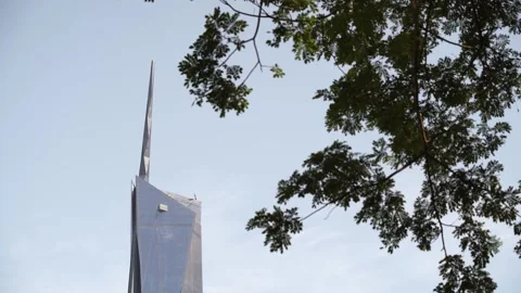 Merdeka 118  tower rises against a minimalist blue sky background Видео 317321166