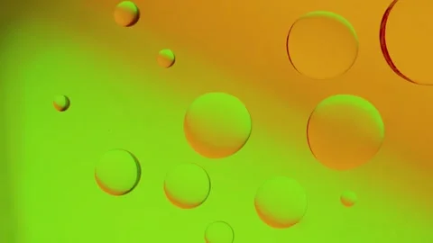 Merging drops on yellow-green gradient background. Vídeo Stock 303058835