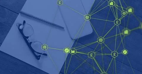 Merging items on desk with green network overlay showing nodes, eyeglasses Fotos de archivo