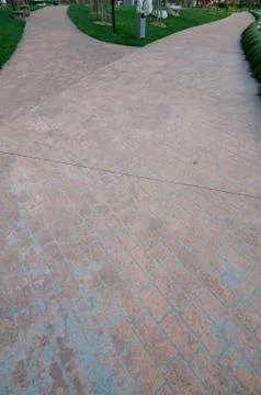 Merging red brick path in a park Stock Photos