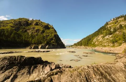 Merging of two rivers in the mountains Stock Photos
