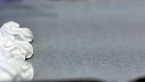 Meringue is laid out on a baking sheet, homemade pastries, cake, cookies made at Stock Footage 76301653