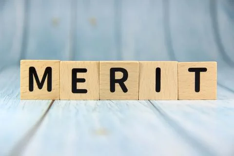 "MERIT" text or message short word english letter on wooden block with blue.. Stock Photos