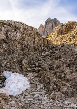 Merizing mountains with sharp peaks. Hiking wooden path leading to mounta Stock Photos