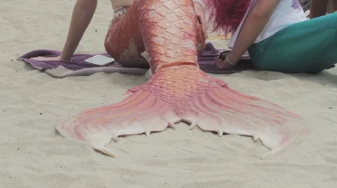Mermaid flapping her  pink tail on a sandy beach Stock Footage 50148246