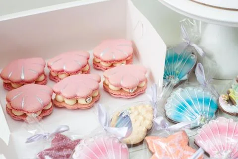 Mermaid theme candy bar with cake, cupcakes, macaroons and biscuits. Sea shel Stock Photos
