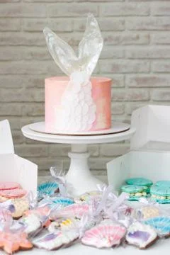 Mermaid theme candy bar with cake, cupcakes, macaroons and biscuits. Sea shel Stock Photos